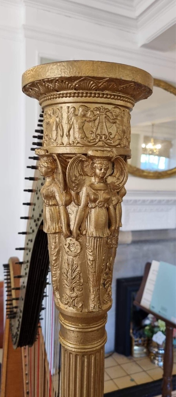 Annemarie seated with harp